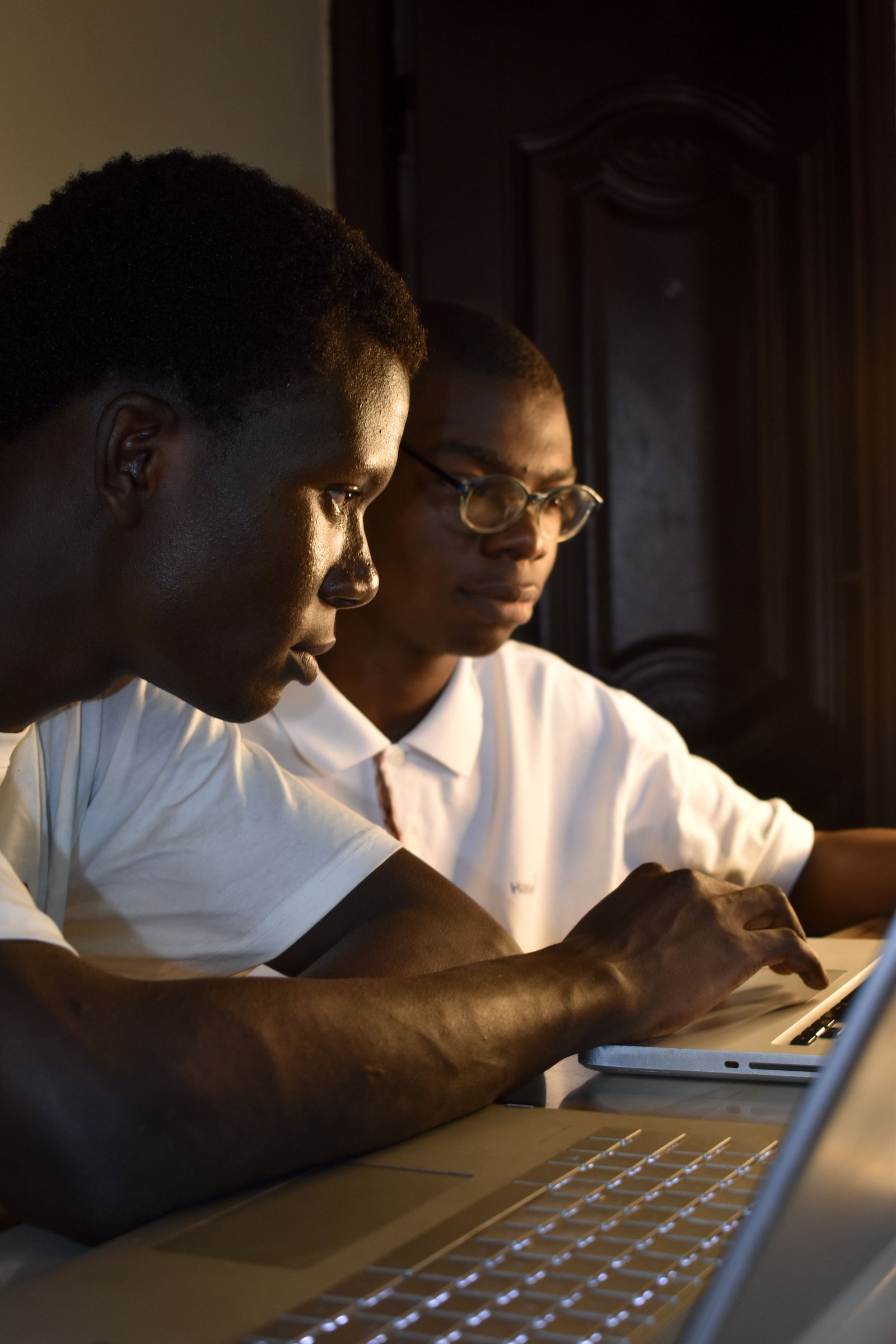 Two learners studying together on a laptop